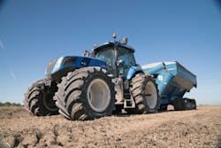 Titan-blue-New-Holland_tractor-with-towed_wagon-resized