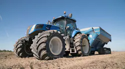 Titan-blue-New-Holland_tractor-with-towed_wagon-resized