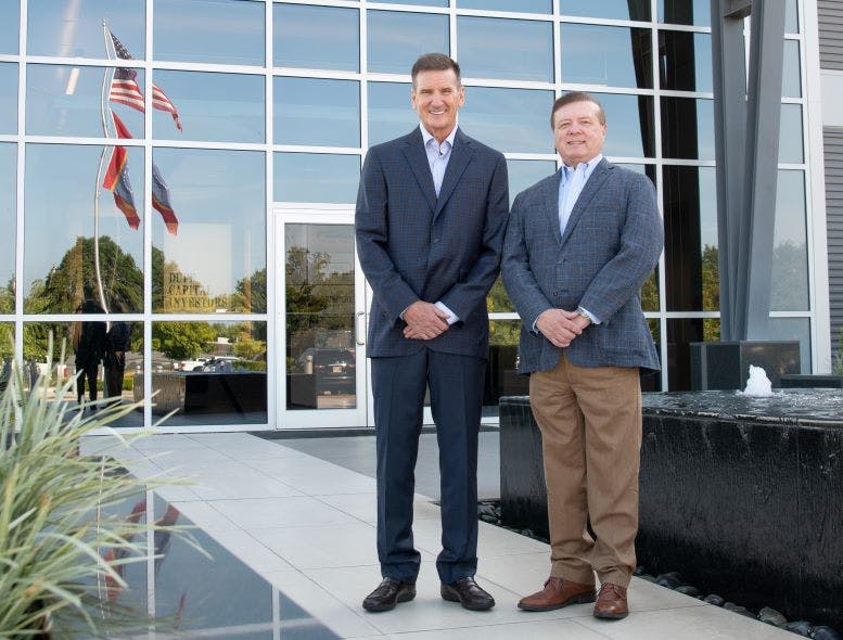 Southern Tire Mart 'has been the engine for the growth of everything we have,' says Jim Duff, left, with Tommy Duff, outside the company's headquarters in Columbia, Miss.