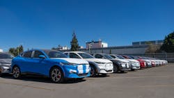 A line of electric Mustang Mach-E vehicles sits outside the factory, ready to ship to customers. A line of electric Mustang Mach-E vehicles sits outside the factory, ready to ship to customers.