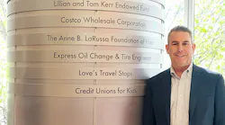 Jim Durkin, CEO of Express Oil Change & Tire Engineers, stands beside the pillar at Children's of Alabama hospital that bears the company's name for its longtime support.