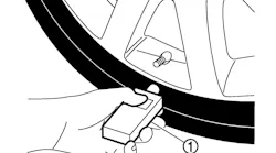 When memorizing the tire pressure sensor ID, hold the activation tool against the side of the tire, near the valve stem.