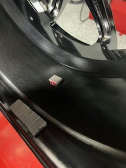 A small amount of weight is needed to achieve optimal balance. Here, the tape weight is placed at the center mass of the assembly. A small amount of weight is needed to achieve optimal balance. Here, the tape weight is placed at the center mass of the assembly.