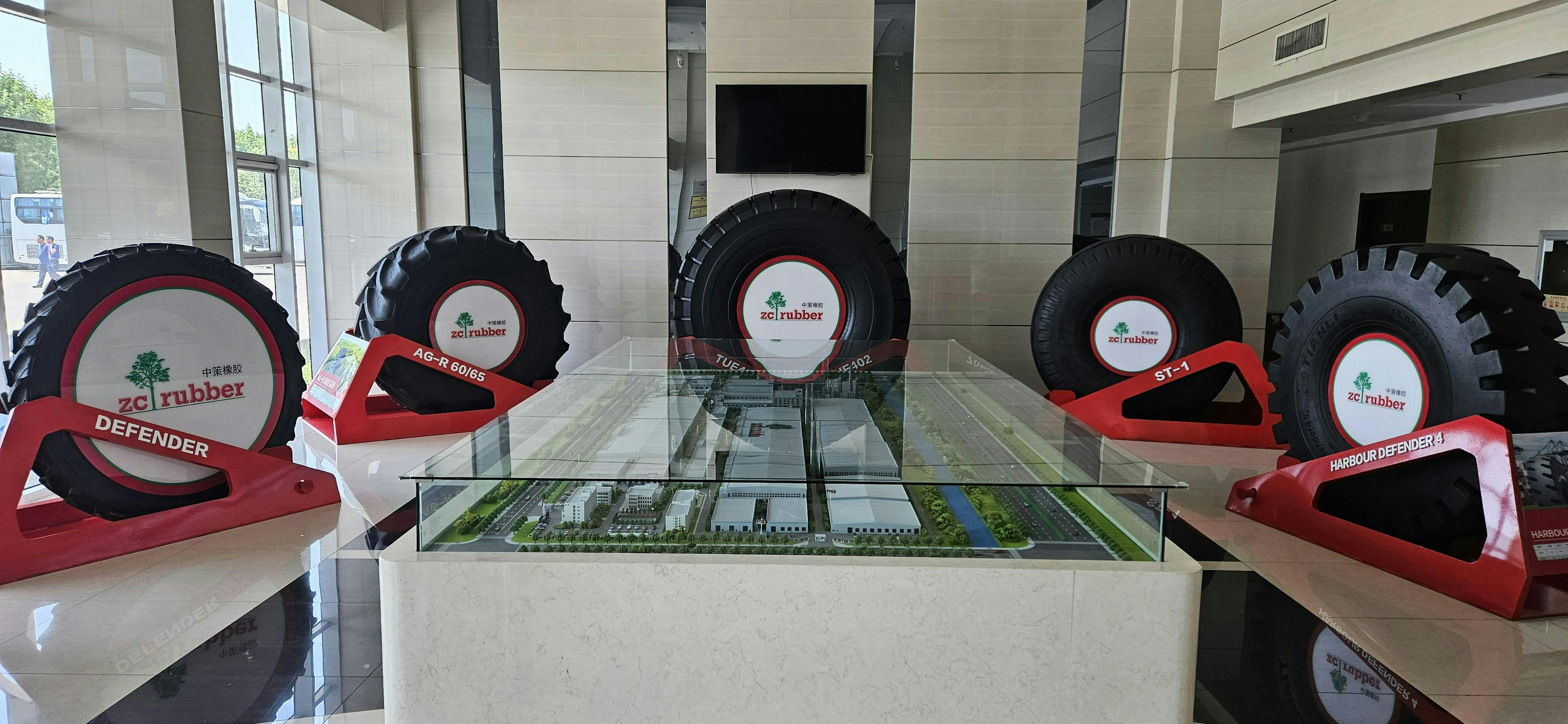 Various tires and a miniature scale model decorate the lobby of ZC Rubber's Tianjin, China, factory.