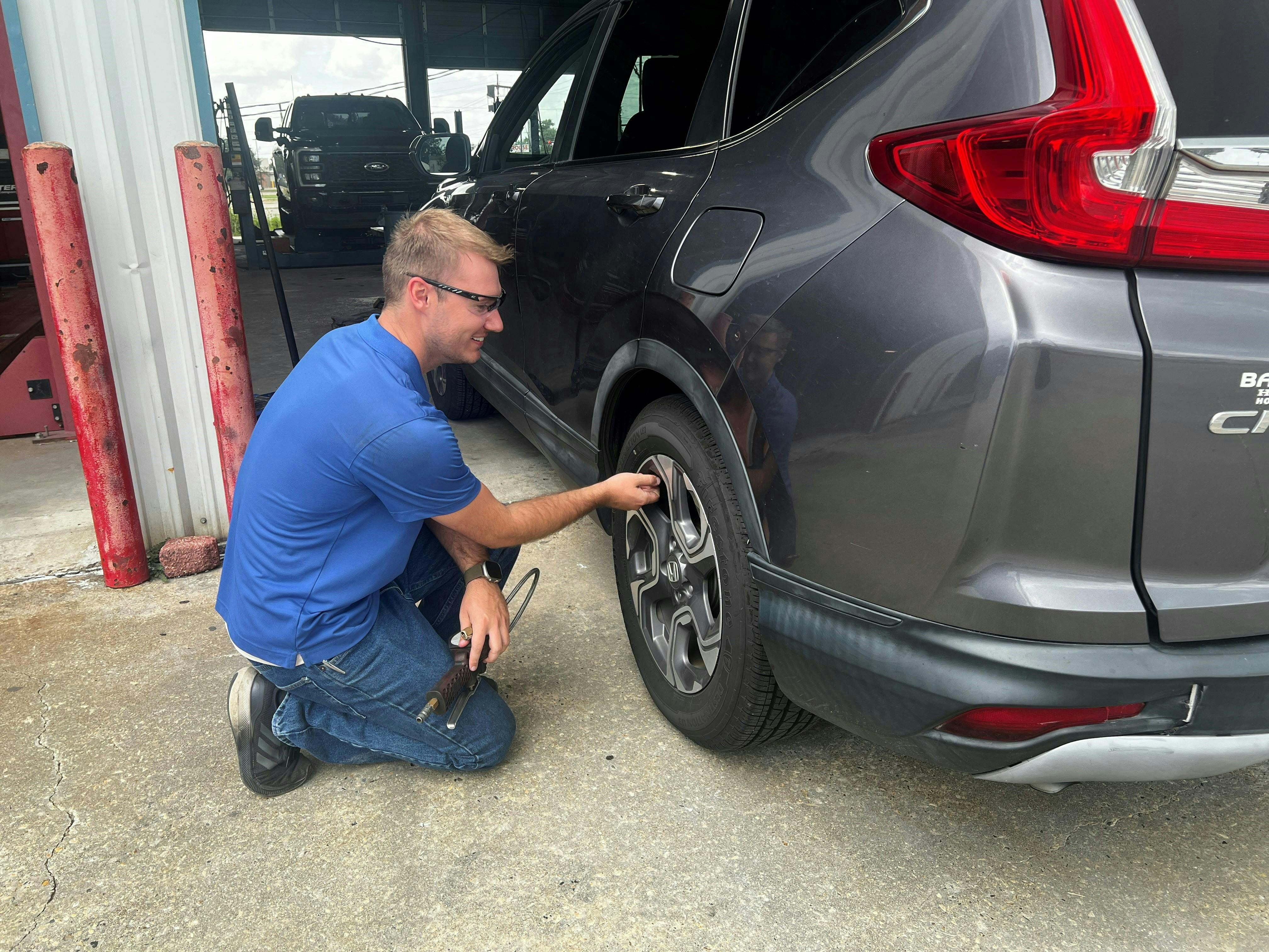 Dillon Brown, a service advisor at a Chabill's Tire & Auto Service store in Houma, checks the air pressure and condition of a customer's leaky tire. A nail was the culprit, and it was in a spot where tire replacement was the only option.