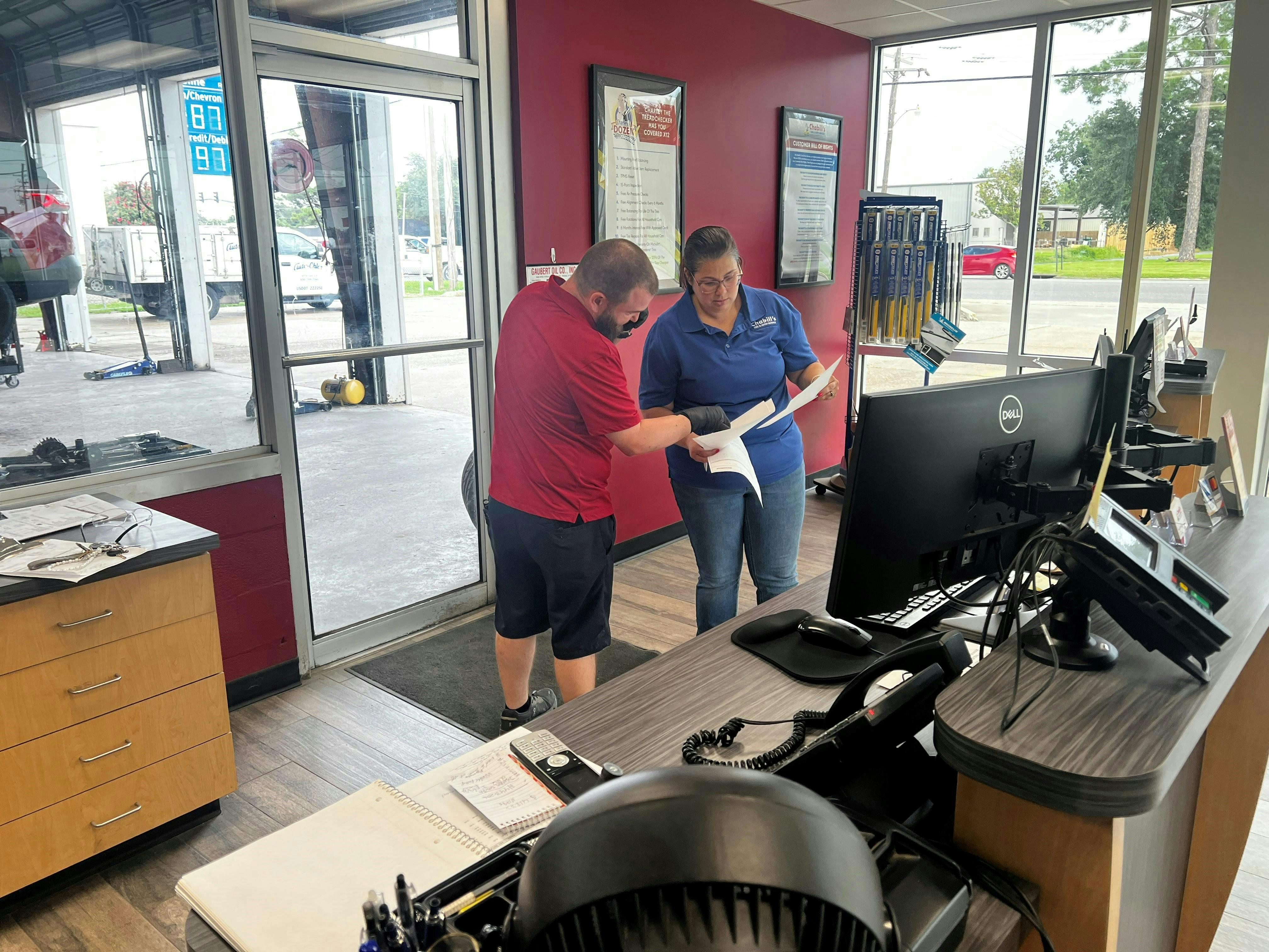 Russ Disalvo and Gwen Naquin, the manager and service advisor at a store in Houma, review the work orders that still need attention before the close of a work day. The summer heat in the Gulf brings with it the busiest season for Chabill's Tire & Auto Service.