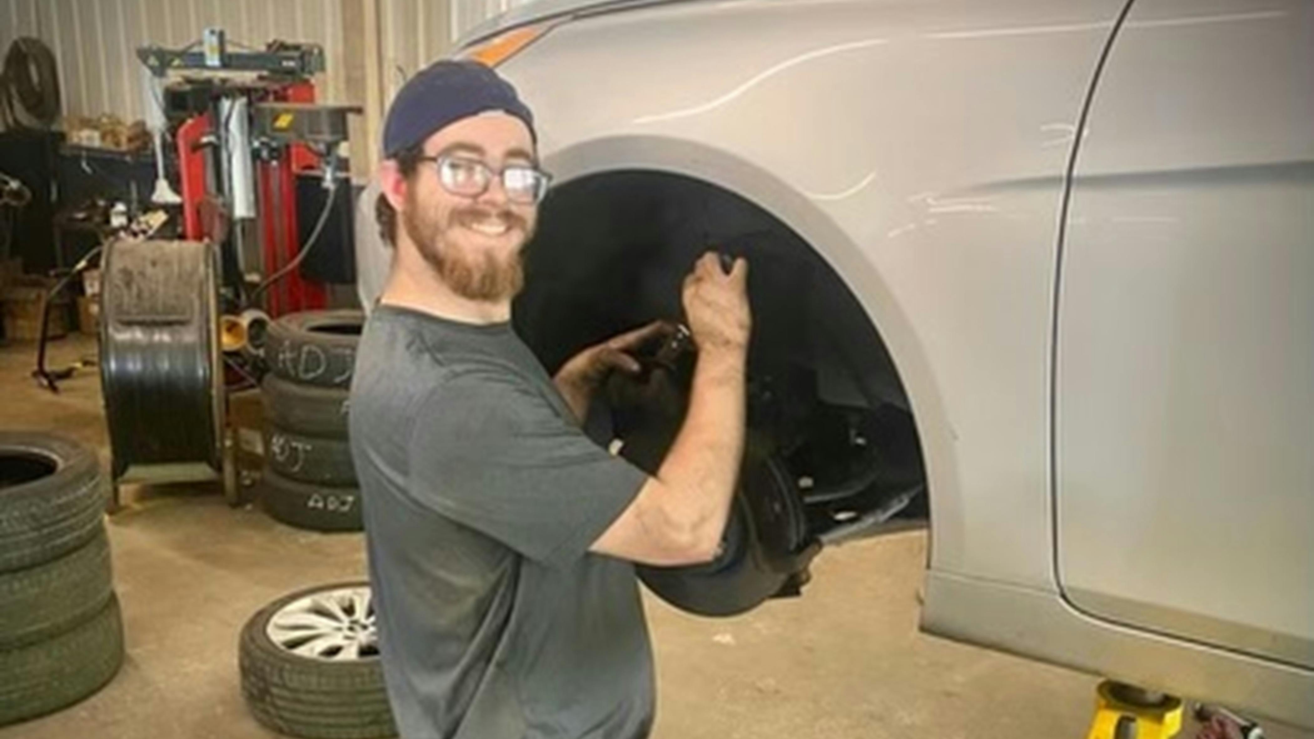 Jake Zanavich uses American Sign Language (ASL) to communicate with other Skander Tire & Auto Service team members.