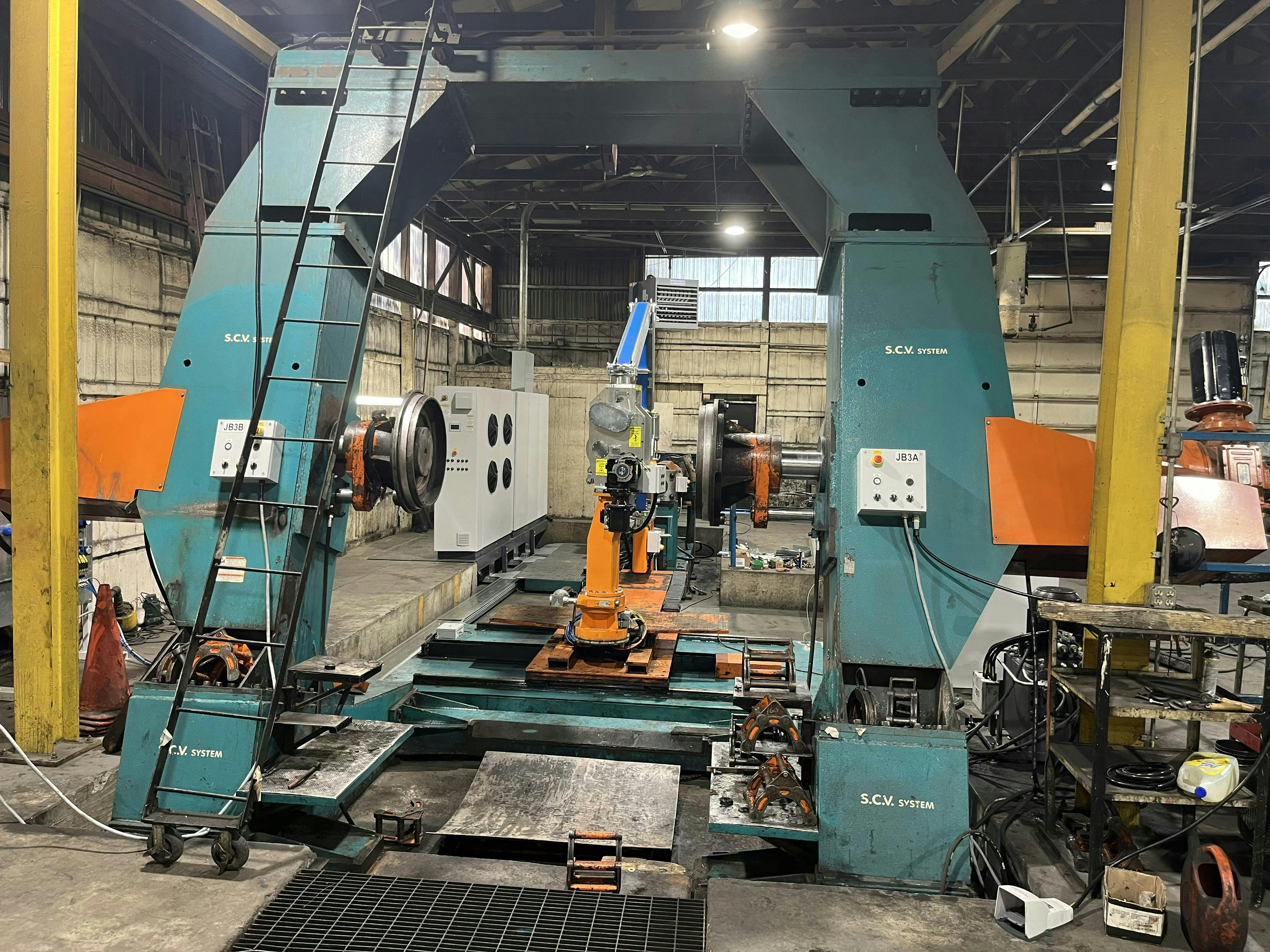 The new builder has improved computer control panels with easier operation, hydraulic systems for the tire hubs, an improved rubber rope conveyor system to reduce uncured rubber breakage and two lasers for dual control measurements.
