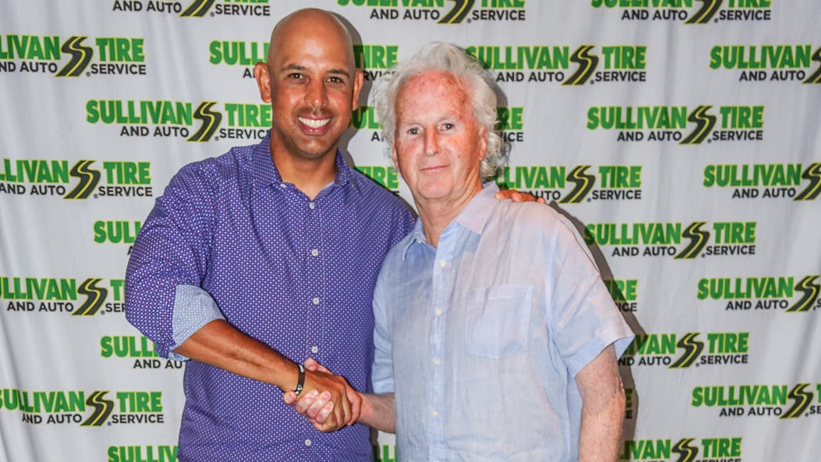 Alex Cora, manager of the Boston Red Sox (left), shakes hands with Paul Sullivan, vice president of marketing for Norwell, Mass.-based Sullivan Tire Co. Inc.