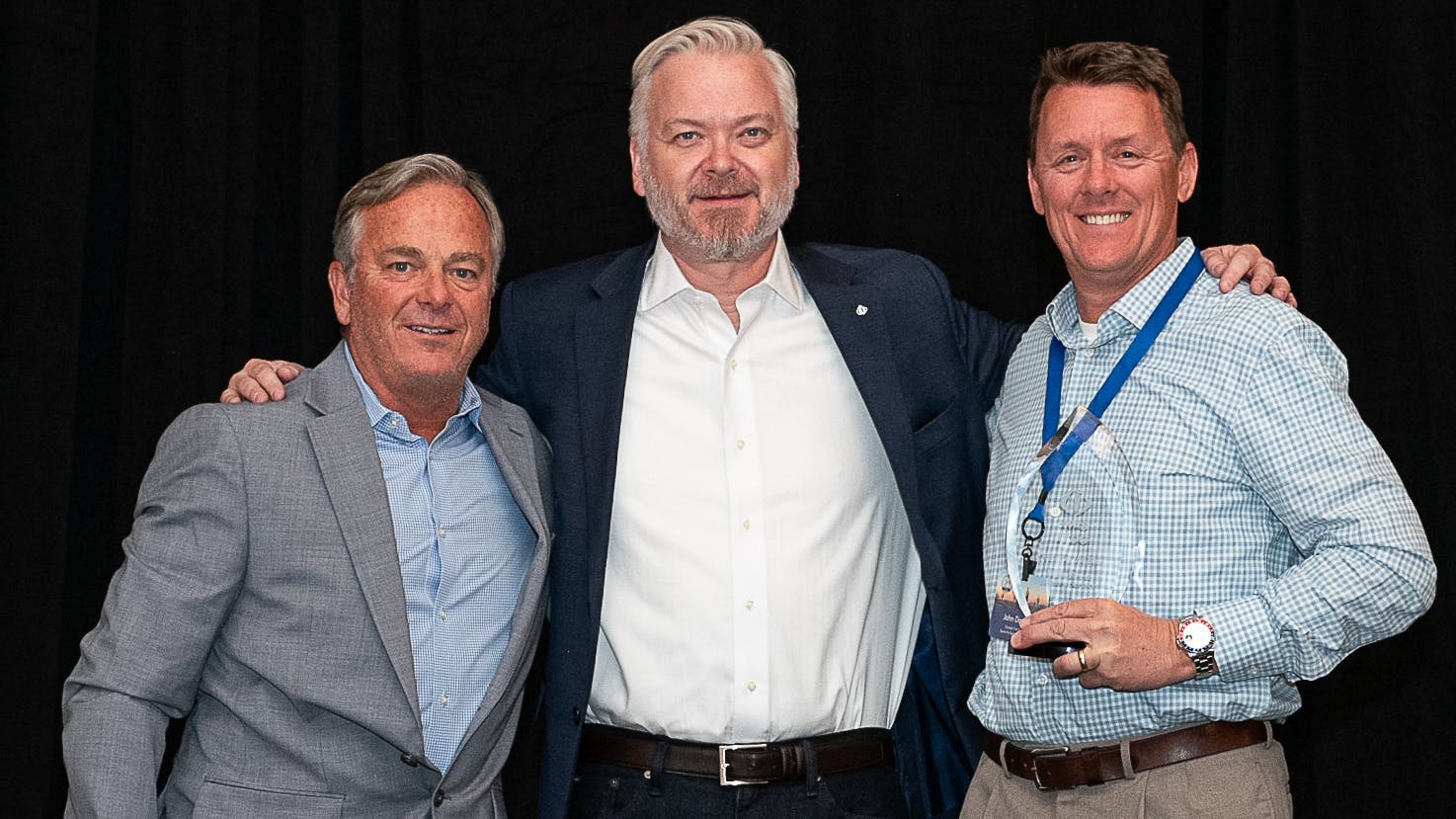 Chris Barry, vice president of sales for the Independent Tire Dealers Group LLC (ITDG), pictured on far left, and ITDG President and CEO Jason Rook (center) presented the ITDG Dealer of the Year Award to John Daniels of Santa Fe Springs, Calif.-based Daniels Tire Service Inc (right, holding trophy.)