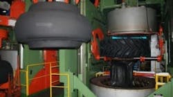 A green tire inside a clamshell mold. A green tire inside a clamshell mold.