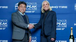 John Yoon, Kumho Tire U.S.A. senior vice president of marketing, and Melissa Eickhoff, CEO of the Pikes Peak Hill Climb, shake hands during a signing ceremony for the Kumho Tire Gaining Traction Program on January 28, 2026.