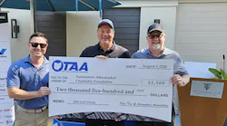 Jamie Ward, current OTAA president and president/CEO of Tire Discounters Inc. (right), and Alex Boehnke, executive director of the OTAA (left), present a donation to John Kairys (center), executive director of the AACF.