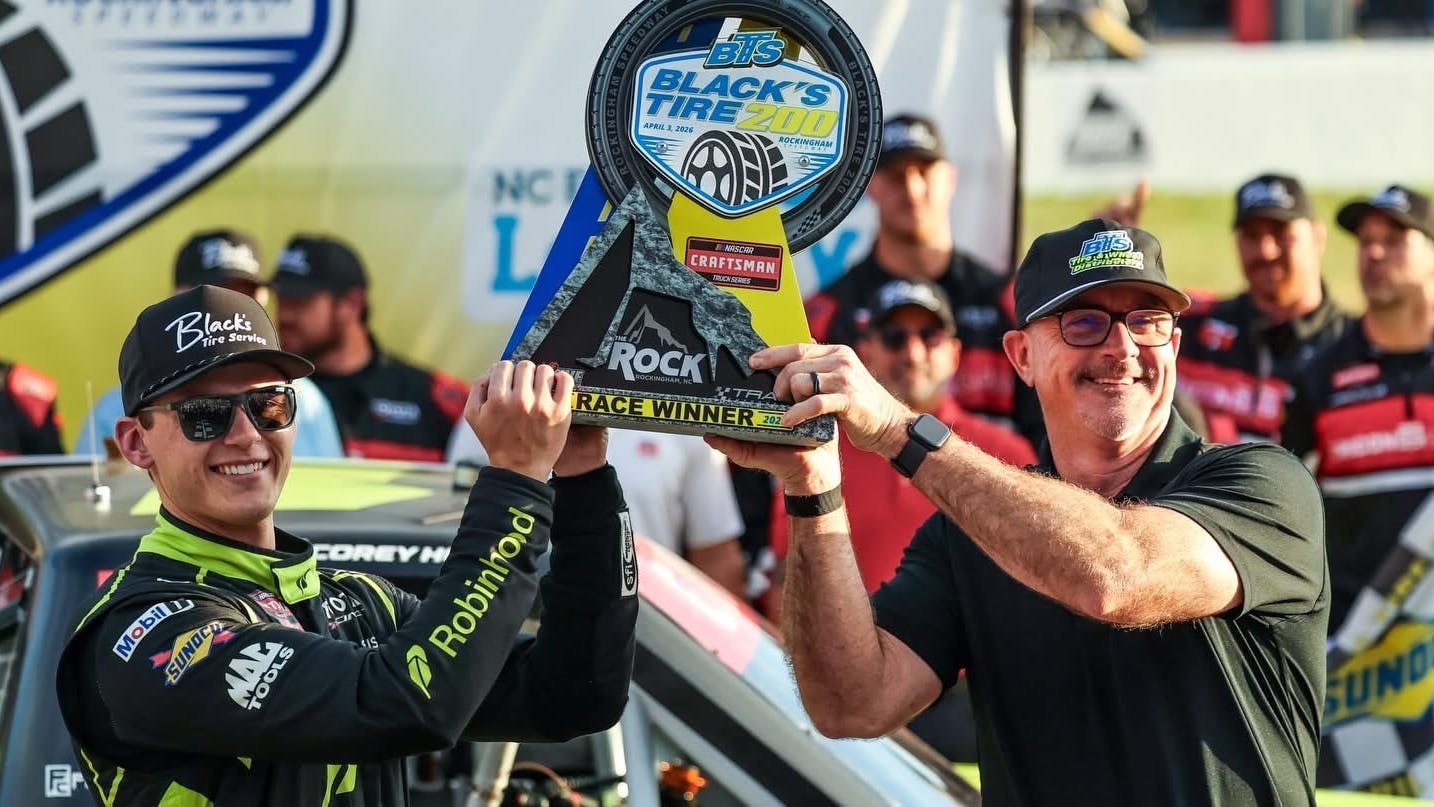 Ricky Benton II, vice president of Black's Tire, presents the Black&rsquo;s Tire 250 NASCAR Craftsman Truck Series trophy to Corey Heim at Rockingham Speedway last April.