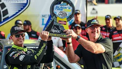 Ricky Benton II, vice president of Black's Tire, presents the Black’s Tire 250 NASCAR Craftsman Truck Series trophy to Corey Heim at Rockingham Speedway last April.
